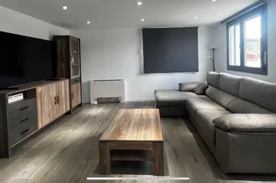 a living room with a couch and a flat screen tv at Villa Oasis entre Viñedos cerca de Barcelona con A A y piscina climatizada in Caserío de Caʼn Rosell