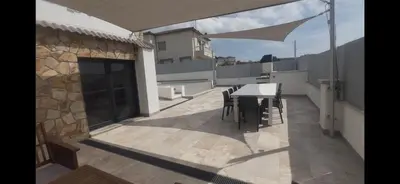 a balcony of a house with a table and chairs at Villa Oasis entre Viñedos cerca de Barcelona con A A y piscina climatizada in Caserío de Caʼn Rosell