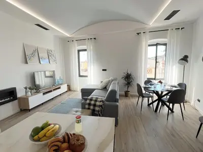a living room with a couch and a table at Ses Voltes Boutique Home Sea and Sky in Vilassar de Dalt