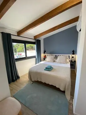a bedroom with a bed and a large window at Ses Voltes Boutique Home Sea and Sky in Vilassar de Dalt