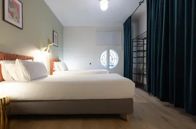 a bedroom with two beds and a window at Stay U-nique Apartment Gran Via IV in Barcelona