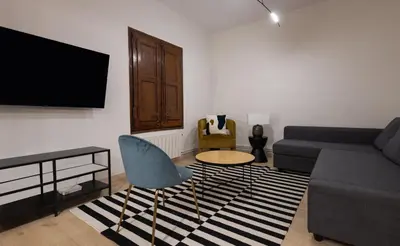 a living room with a couch and a table at Stay U-nique Apartment Gran Via IV in Barcelona