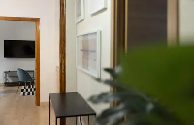 a living room with a table and a television at Stay U-nique Apartment Gran Via IV in Barcelona