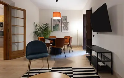 a living room with a dining room table and chairs at Stay U-nique Apartment Gran Via IV in Barcelona
