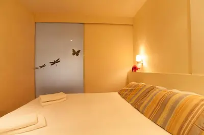 a bedroom with a white bed with butterflies on the wall at Rambla Suites in Barcelona