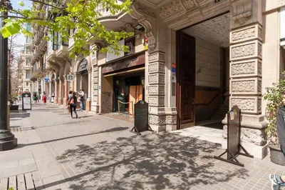 a street with people walking down a sidewalk at Rambla Suites in Barcelona
