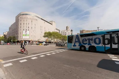 a person riding a bike in front of a bus at Rambla Suites in Barcelona