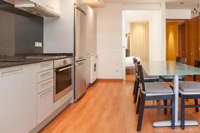 a kitchen with a table and chairs in a room at Rambla Suites in Barcelona