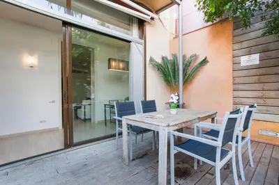 a wooden table and chairs on a patio at Tendency Apartments 7 in Barcelona