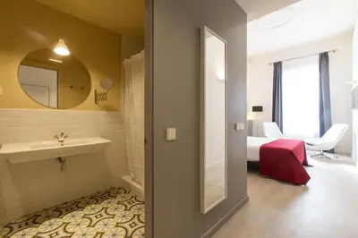 a bathroom with a sink and a mirror at Izaila Plaza Catalunya in Barcelona