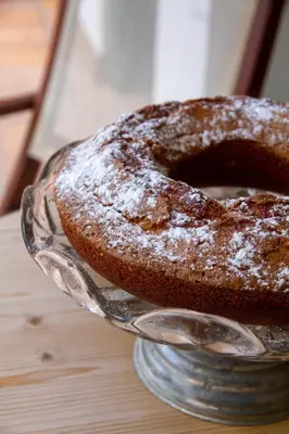 a cake sitting on a glass plate on a table at Bell Plançó B&B in Moià