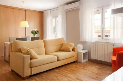a living room with a couch and a table at LetsGo Sagrada Familia Penthouse in Barcelona