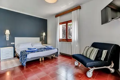 a bedroom with a bed and a chair at Casa en Sitges in Sitges
