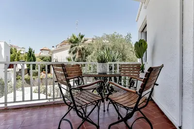 a patio table and chairs on a balcony at Casa en Sitges in Sitges