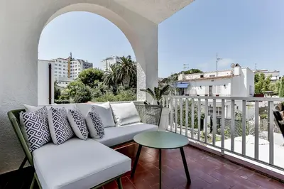 a balcony with a couch and a table at Casa en Sitges in Sitges