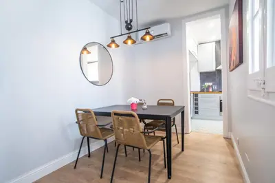 a dining room with a black table and chairs at Tendency Apartments Miro 6 in Barcelona