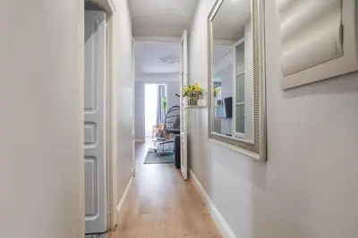 a hallway with white walls and a mirror on the wall at Tendency Apartments Miro 6 in Barcelona