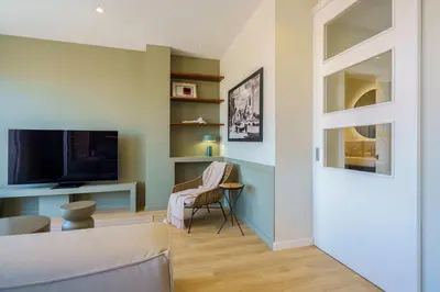 a living room with a couch and a tv at Sitges Spaces Mediterranean Penthouse in Sitges