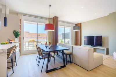 a kitchen and dining room with a table and chairs at Sitges Spaces Mediterranean Penthouse in Sitges