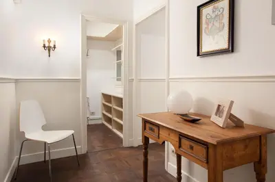 a room with a wooden table and a chair and a desk at Letsgo Camp Nou Apartment in Barcelona