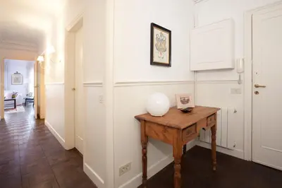 a hallway with a wooden table in a room at Letsgo Camp Nou Apartment in Barcelona