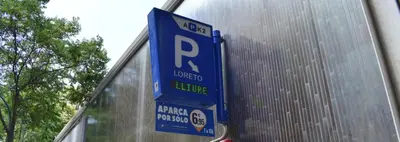 a blue parking sign in front of a building at Letsgo Camp Nou Apartment in Barcelona