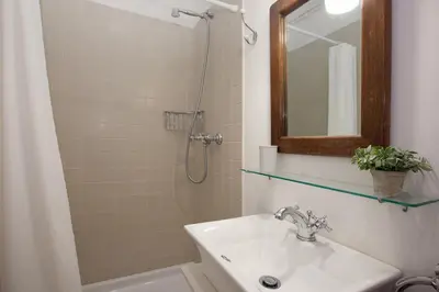 a bathroom with a sink and a shower with a mirror at Letsgo Camp Nou Apartment in Barcelona