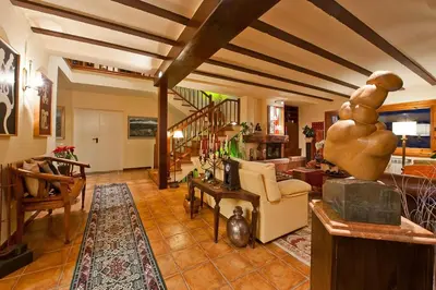 a bedroom with a large bed and a desk and windows at Fantástica casa con vistas al mar in Arenys de Munt