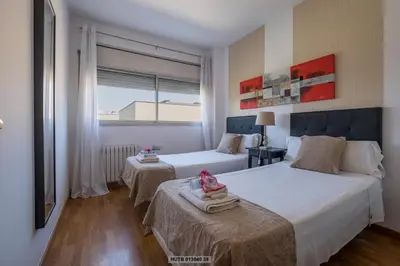 a hotel room with two beds and a window at Alcam Vila Olímpica in Barcelona