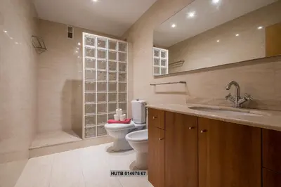a bathroom with a toilet and a tub and a sink at Alcam Vila Olímpica in Barcelona