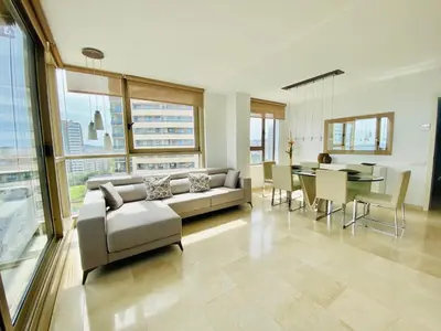 a large living room with a couch and a table at Akira Flats Diagonal Mar Apartments in Barcelona