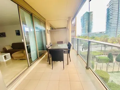 a balcony with a table and chairs in a room at Akira Flats Diagonal Mar Apartments in Barcelona