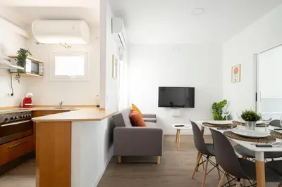 a kitchen and living room with a table and chairs at APARTMENT BEACH PICASSO in Sant Adria de Besos