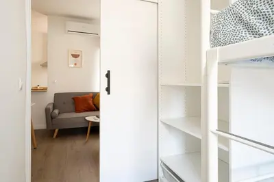 a small apartment with a staircase and a living room at APARTMENT BEACH PICASSO in Sant Adria de Besos