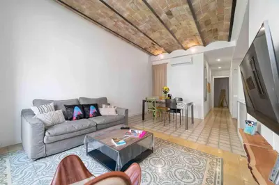 a living room with a couch and a table at Apartamento moderno en Sant Antoni in Barcelona