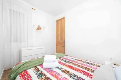 a white bedroom with a bed with towels on it at Apartamento moderno en Sant Antoni in Barcelona