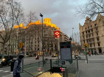 a person walking on a city street with a bus stop at Apartamento moderno en Sant Antoni in Barcelona