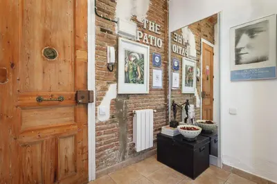 a room with a brick wall and a wooden door at The Patio Barcelona in Barcelona
