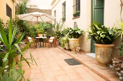 an outdoor patio with plants and a table with an umbrella at The Patio Barcelona in Barcelona