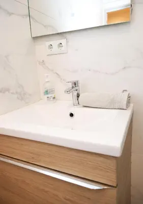a bathroom with a white sink and a mirror at Cozy near the Barcelona Camp Nou Stadium in Barcelona