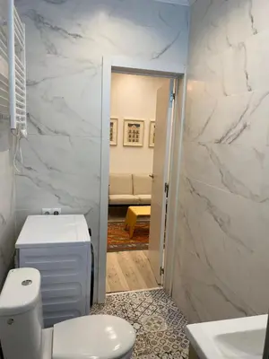 a bathroom with a white toilet and a sink at Cozy near the Barcelona Camp Nou Stadium in Barcelona