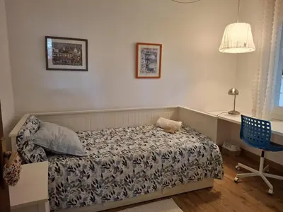 a bedroom with a bed and a desk and a chair at Caldetas in Caldes d'Estrac
