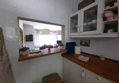 a kitchen with a counter and a mirror on the wall at Caldetas in Caldes d'Estrac
