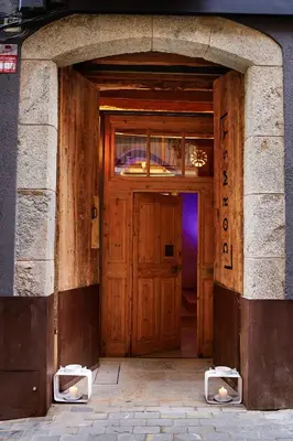 an entrance to a building with a wooden door at Dormsy Pension Boutique in Arenys de Mar
