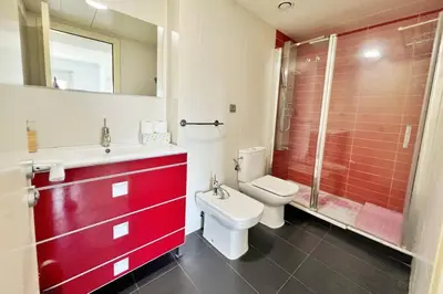 a red bathroom with a toilet and a shower at Ral48 in Sant Adria de Besos