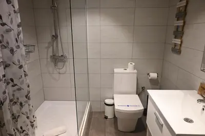 a bathroom with a shower and a toilet and a sink at Homenfun Barcelona Vallcarca in Barcelona
