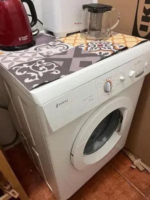 a white washing machine sitting on top of a counter at Loft nearby Sagrada Familia in Barcelona