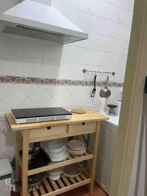 a kitchen with a table with a laptop on it at Loft nearby Sagrada Familia in Barcelona