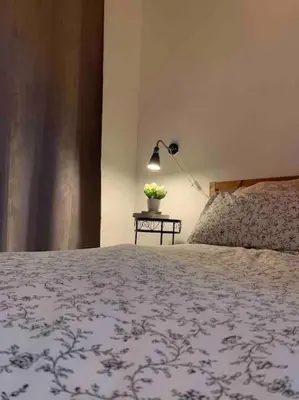 a bedroom with a bed and a table with a lamp at Loft nearby Sagrada Familia in Barcelona