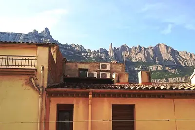 an old building with a mountain in the background at piso con vistas a la montaña in Monistrol